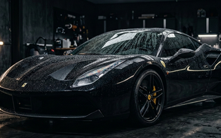 shiny car bonnet with water beads, sunlight, and clean detailing tools in bright setting