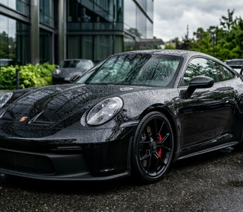 shiny black ceramic coated car with water beads 