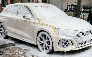 Yellow audi covered in a thick car snow foam